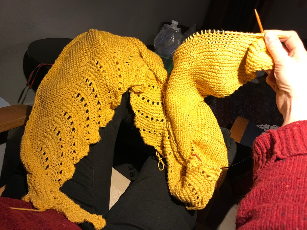 Photo of a knitted wrap, still on the knitting needles